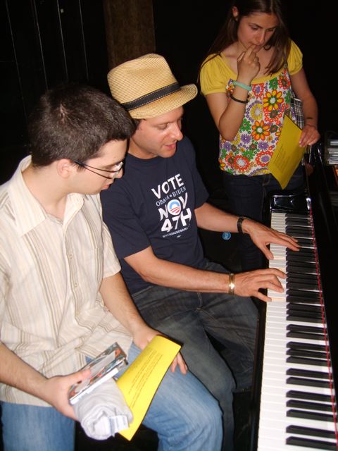 Eli with students at the piano.